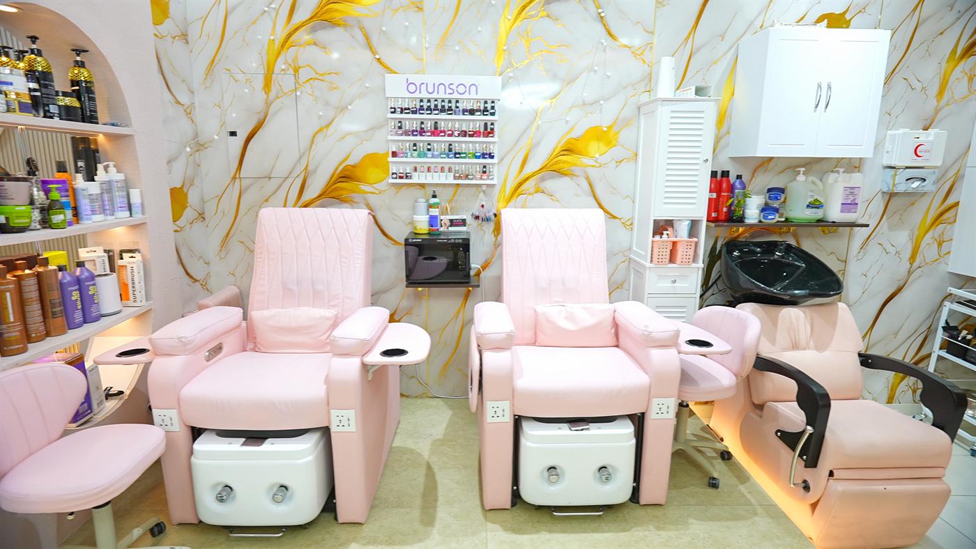 Pink pedicure lounge chairs beside the nail polish display