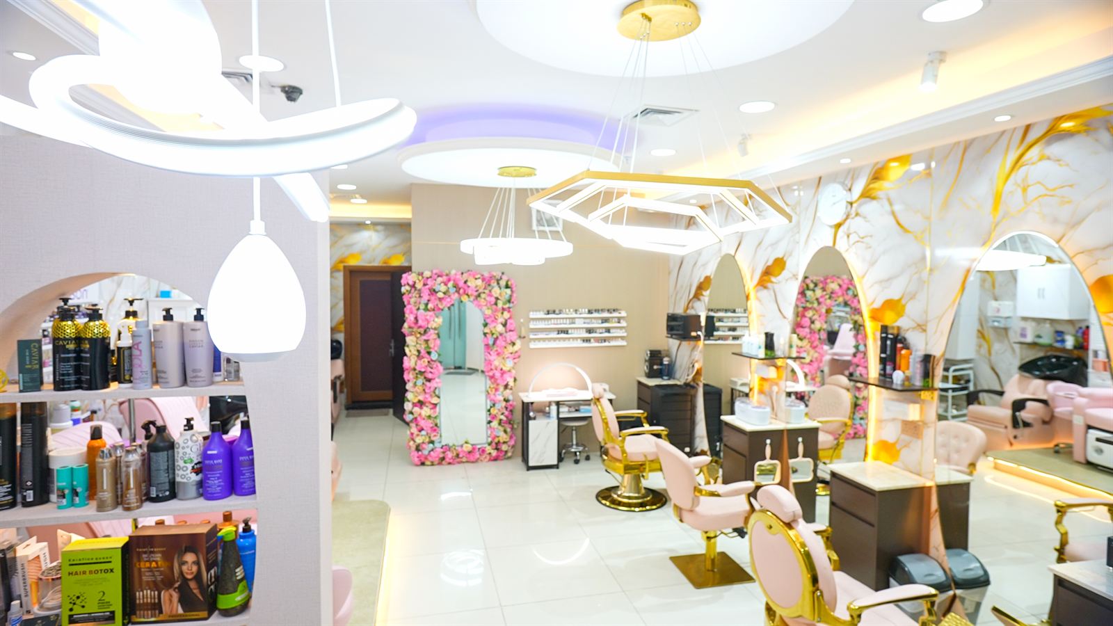 Salon overview with designer chandeliers and product shelves