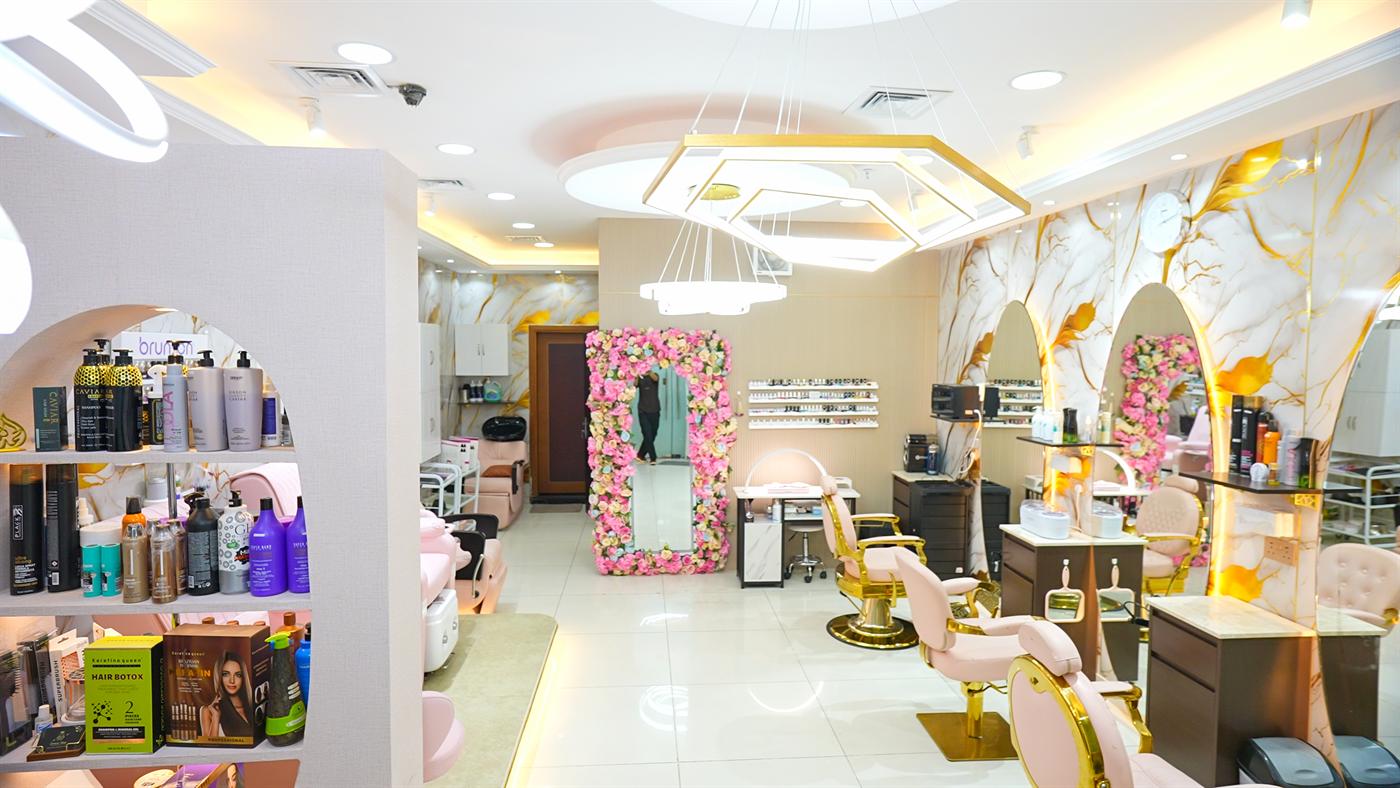Salon interior with floral arch mirror and designer chandeliers