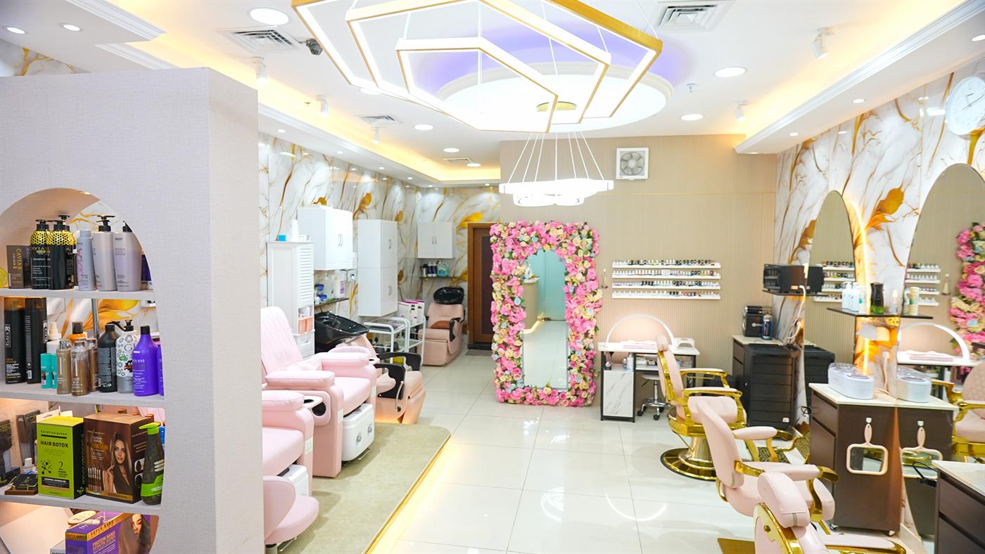 Salon floor with pedicure chairs and gold styling chairs