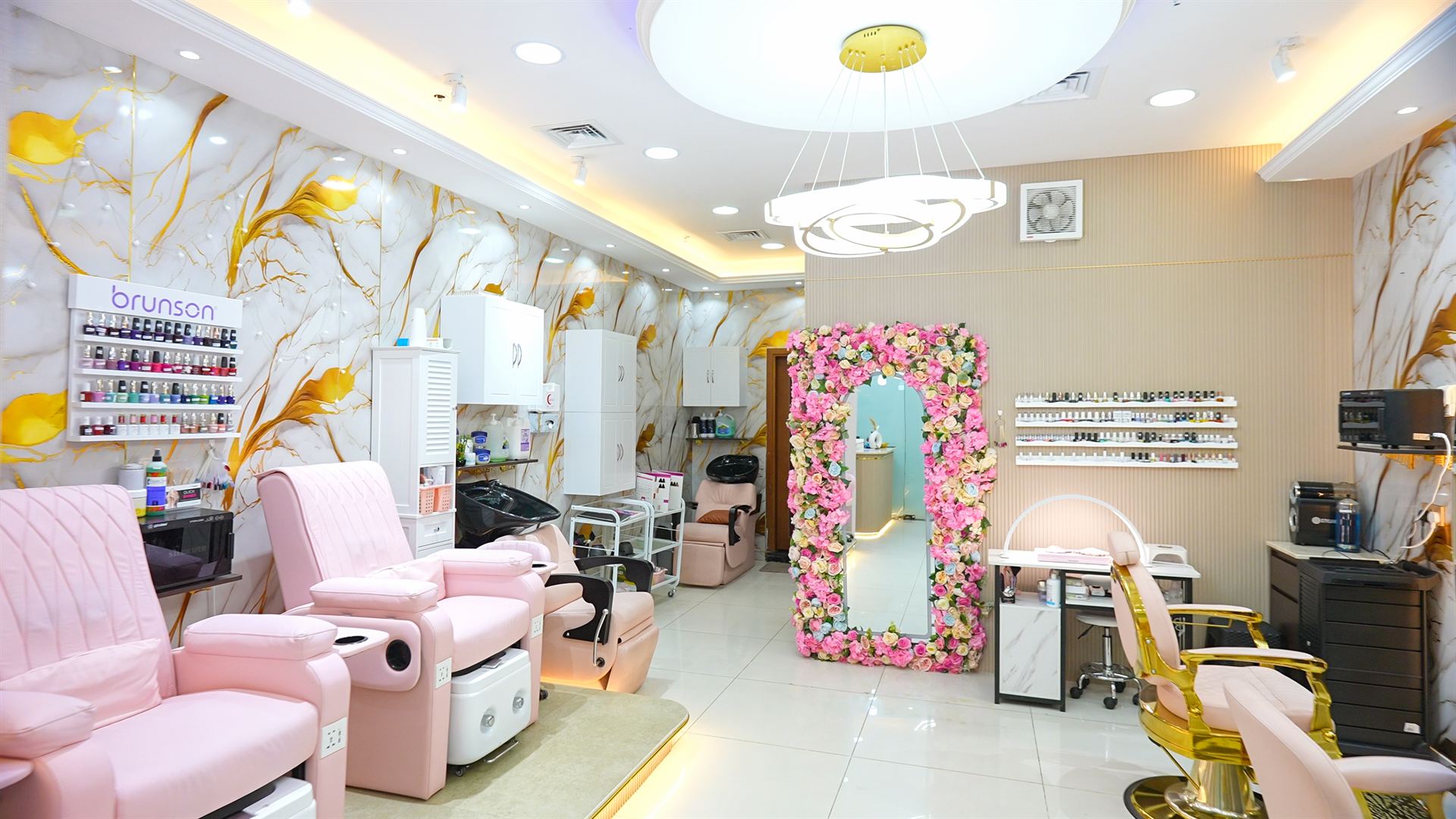 Grove Star Beauty Salon interior with pink pedicure lounge chairs and floral arch mirror